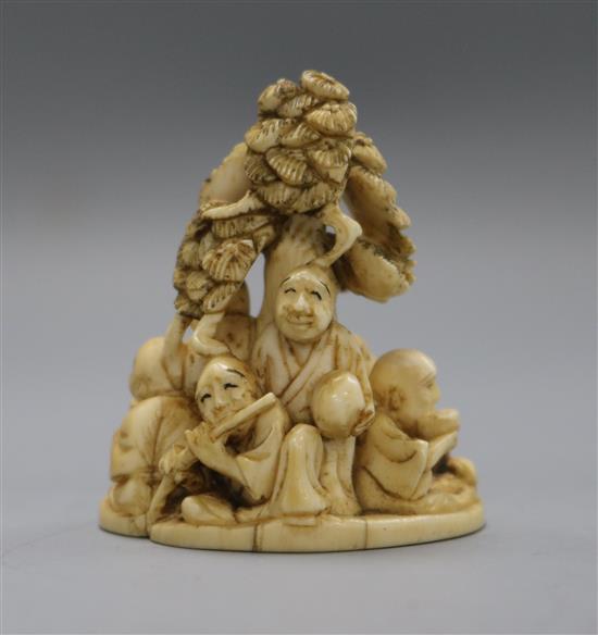 A Meiji period ivory okimono netsuke of rakan beneath a tree (573)